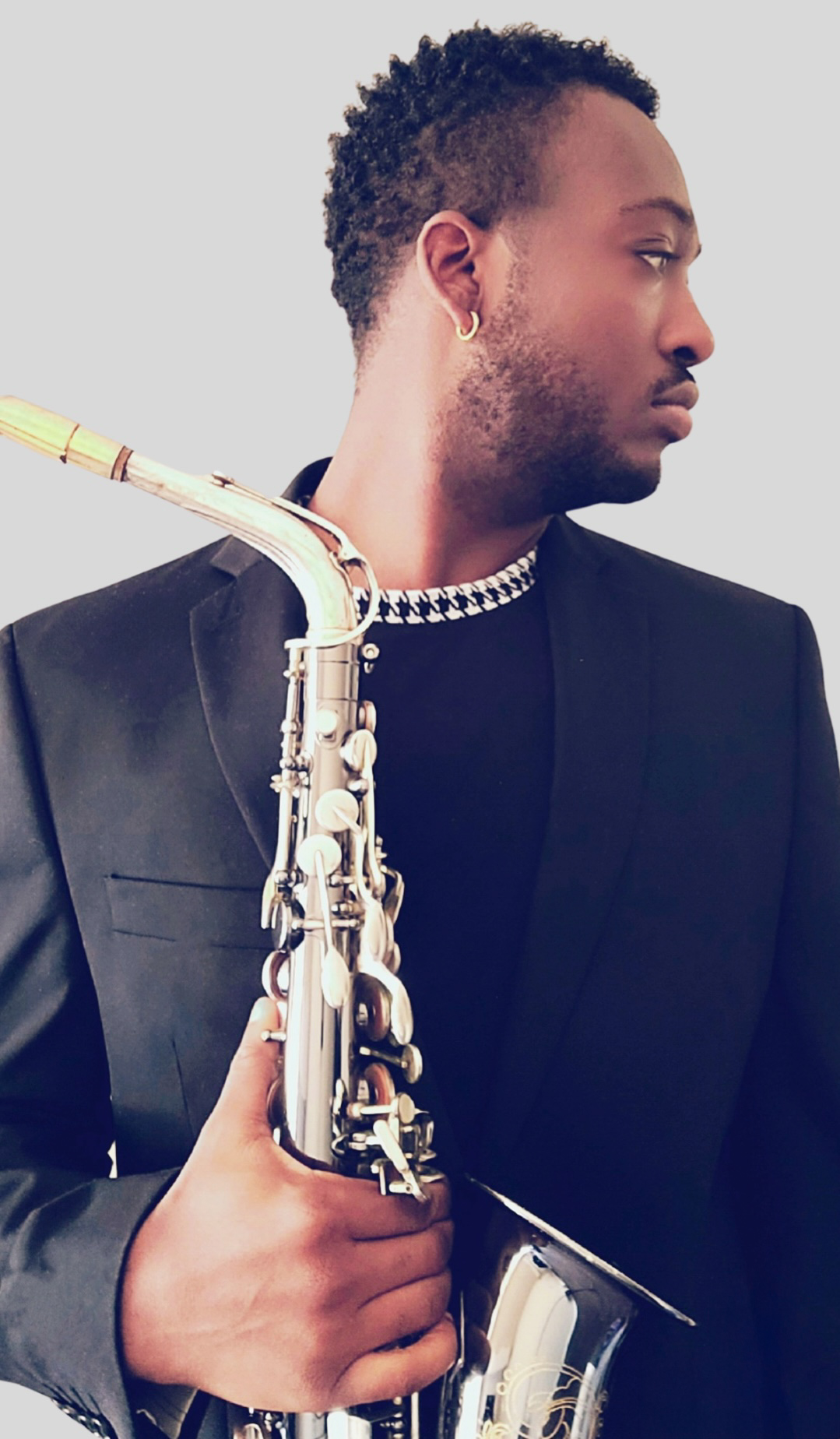TAVE profile portrait holding his saxophone