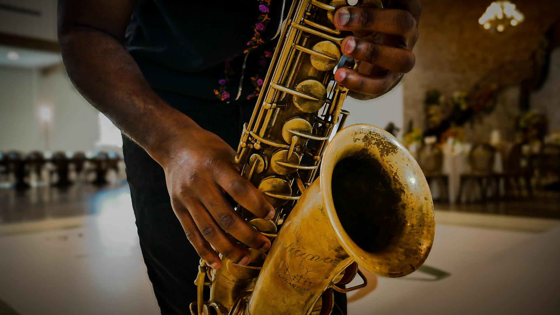 Close-up of vintage saxophone in TAVE’s hands